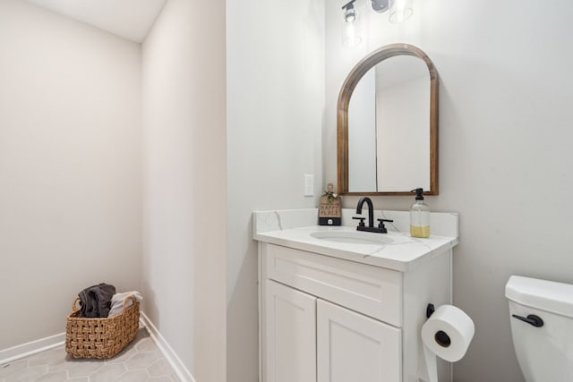 bathroom with tile patterned floors, vanity, and toilet