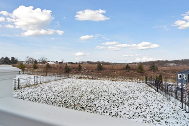 yard layered in snow with a rural view