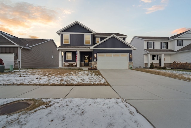 view of front of house featuring a porch and a garage