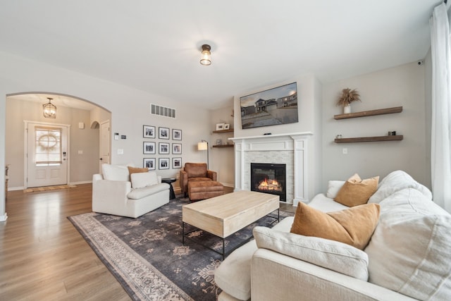 living room featuring wood-type flooring and a notable chandelier