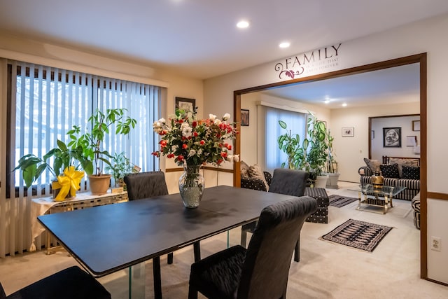 dining room featuring light carpet