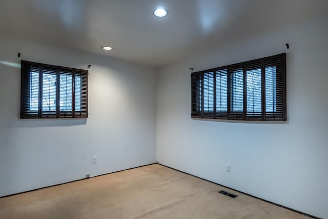 spare room featuring light colored carpet