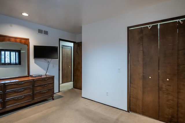 carpeted bedroom featuring a closet