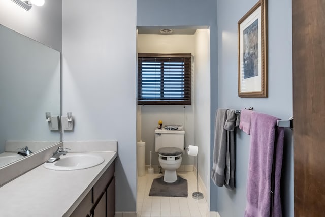 bathroom featuring toilet, tile patterned floors, and vanity