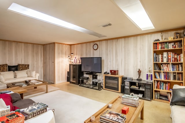 living room with wooden walls and a fireplace