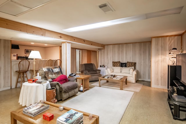 living room with wood walls