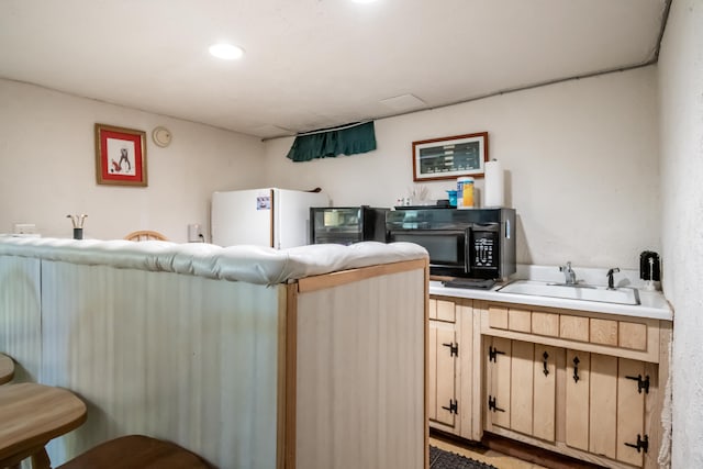 kitchen featuring sink and white refrigerator