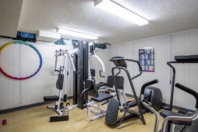 exercise area featuring a textured ceiling