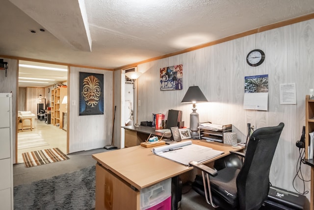 office space with a textured ceiling and wood walls