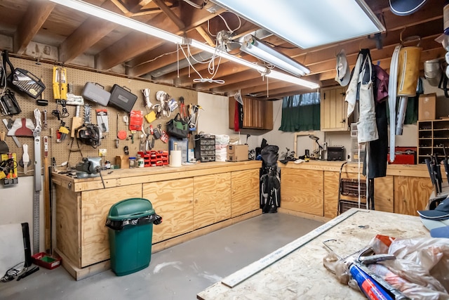 misc room featuring concrete flooring and a workshop area