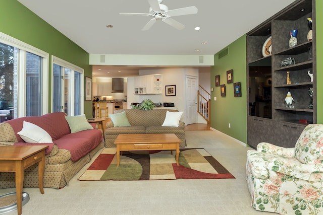 carpeted living room featuring ceiling fan