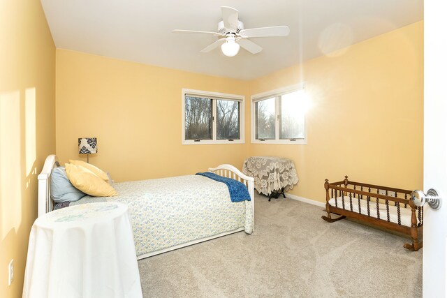 carpeted bedroom featuring ceiling fan