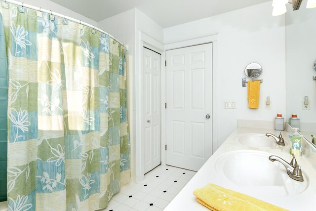 bathroom featuring tile patterned flooring, vanity, and a shower with shower curtain