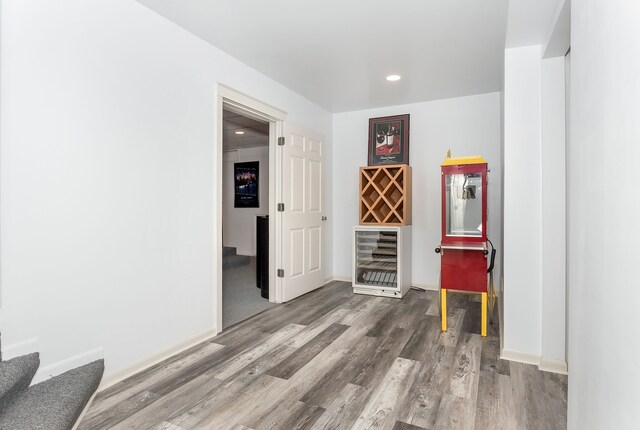 interior space with wood-type flooring and wine cooler