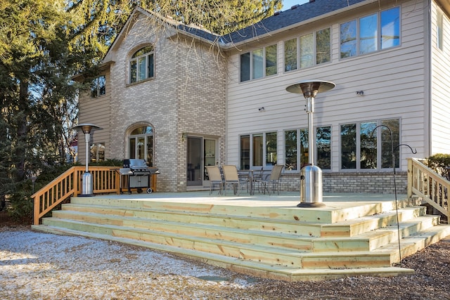 rear view of property with a wooden deck