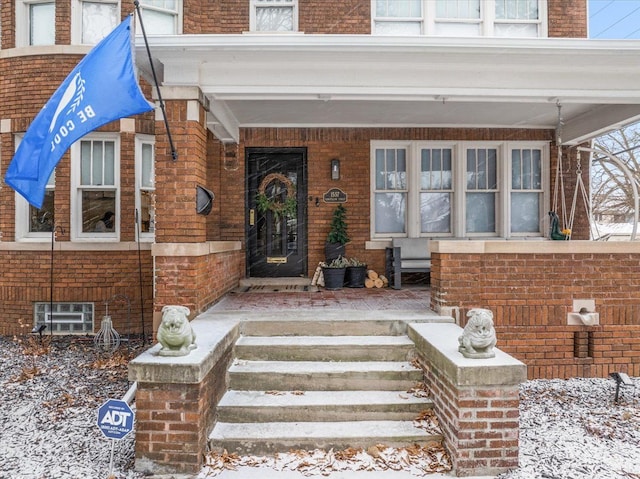 view of snow covered property entrance