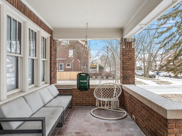 snow covered patio with a porch