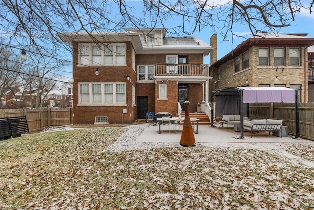 back of house with a balcony, an outdoor hangout area, and a patio