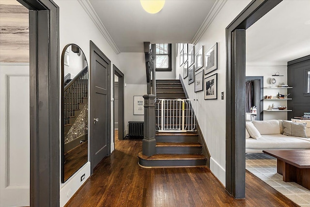 staircase featuring hardwood / wood-style flooring and crown molding