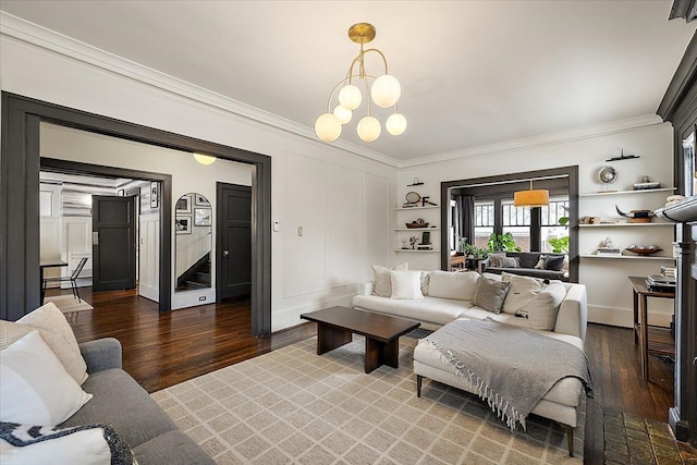 living room featuring a notable chandelier, ornamental molding, and dark hardwood / wood-style floors