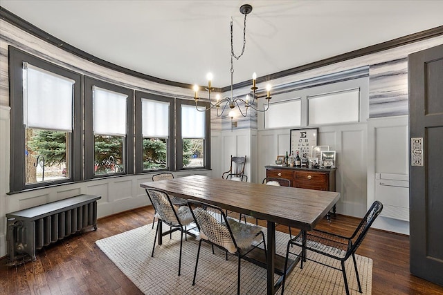 dining area featuring radiator heating unit, ornamental molding, a chandelier, and dark hardwood / wood-style floors