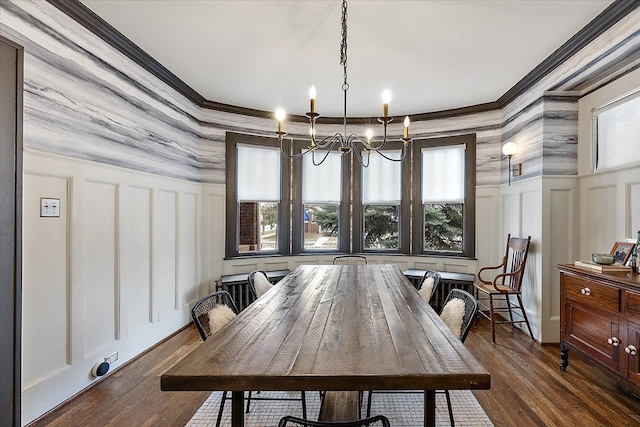 dining space featuring ornamental molding, dark hardwood / wood-style flooring, and an inviting chandelier