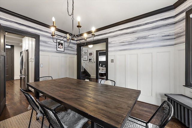 dining area featuring dark wood-type flooring and a notable chandelier