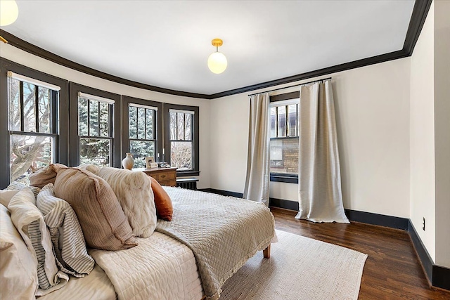 bedroom with crown molding and dark hardwood / wood-style flooring