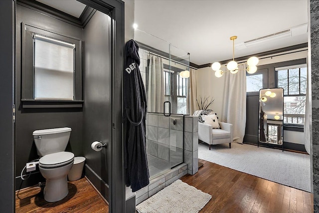 bathroom featuring toilet, ornamental molding, and hardwood / wood-style flooring