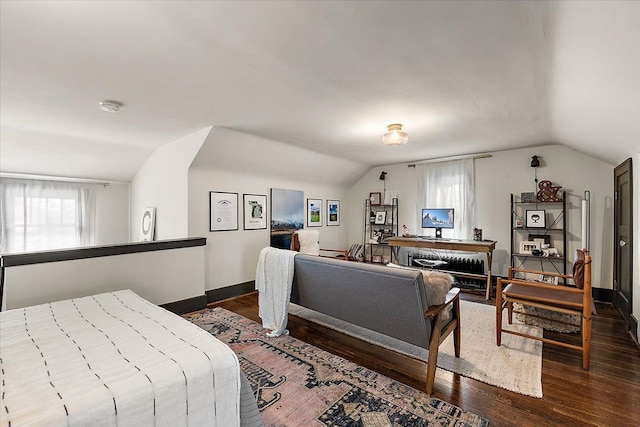 bedroom featuring lofted ceiling and dark wood-type flooring