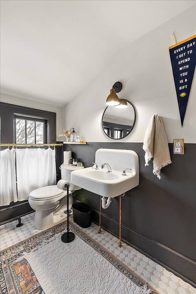 bathroom featuring toilet, tile patterned floors, and sink