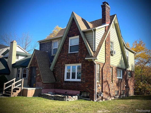 rear view of house featuring a yard and cooling unit