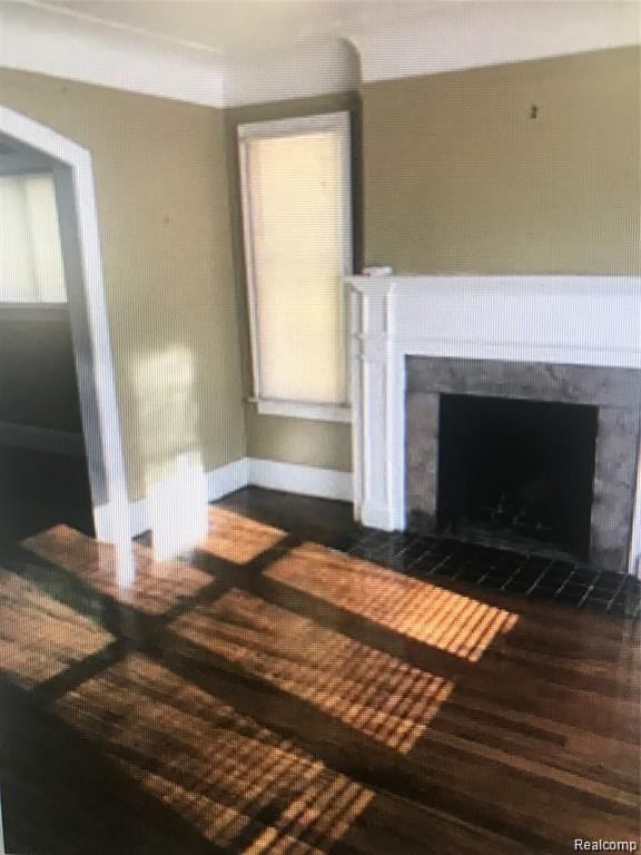 unfurnished living room with dark hardwood / wood-style floors