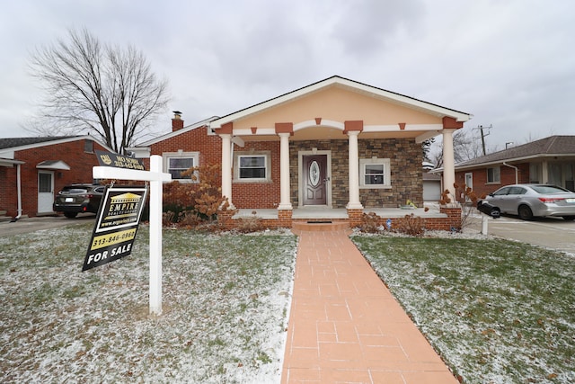 view of front of house with a front yard and a porch