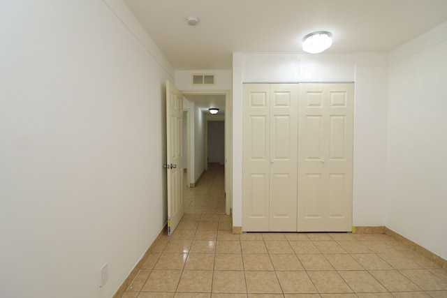 hall featuring light tile patterned floors