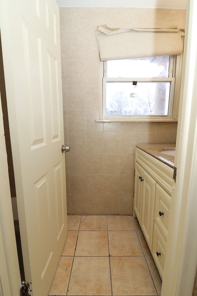 bathroom featuring tile patterned floors, vanity, and tile walls