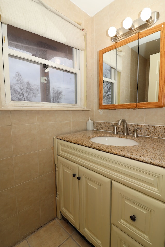 bathroom with vanity, tile patterned floors, and tile walls