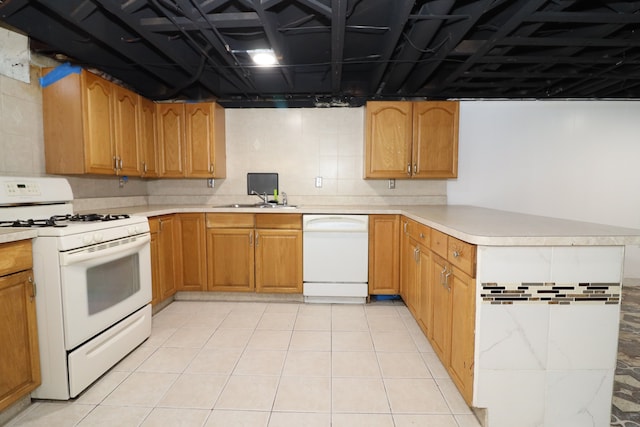 kitchen with white appliances, sink, and light tile patterned floors