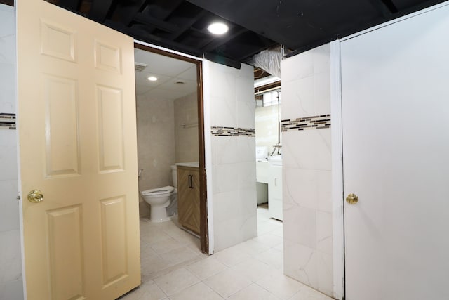 bathroom with tile patterned flooring, vanity, and toilet