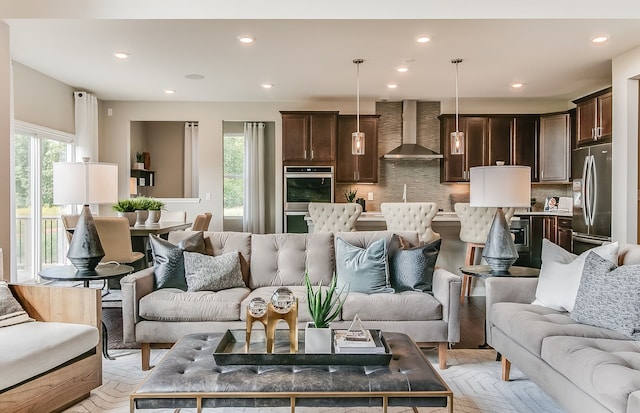 living room featuring sink and light hardwood / wood-style flooring