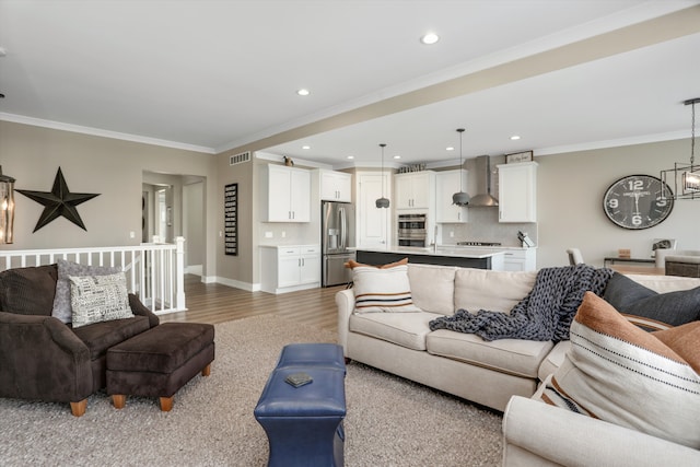 living room with hardwood / wood-style floors, crown molding, and sink