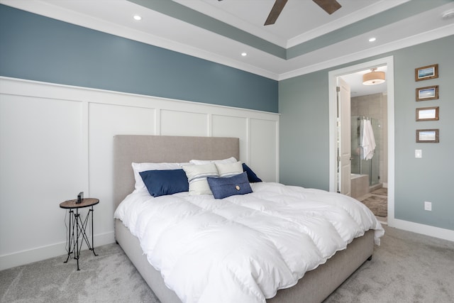 bedroom featuring light carpet, ensuite bath, ceiling fan, and ornamental molding