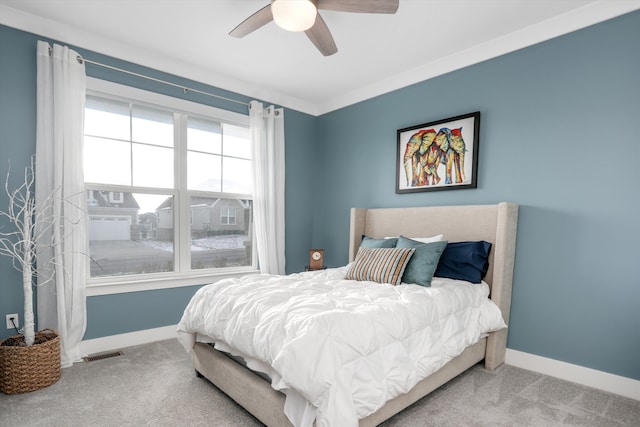 bedroom with ceiling fan, light colored carpet, and ornamental molding