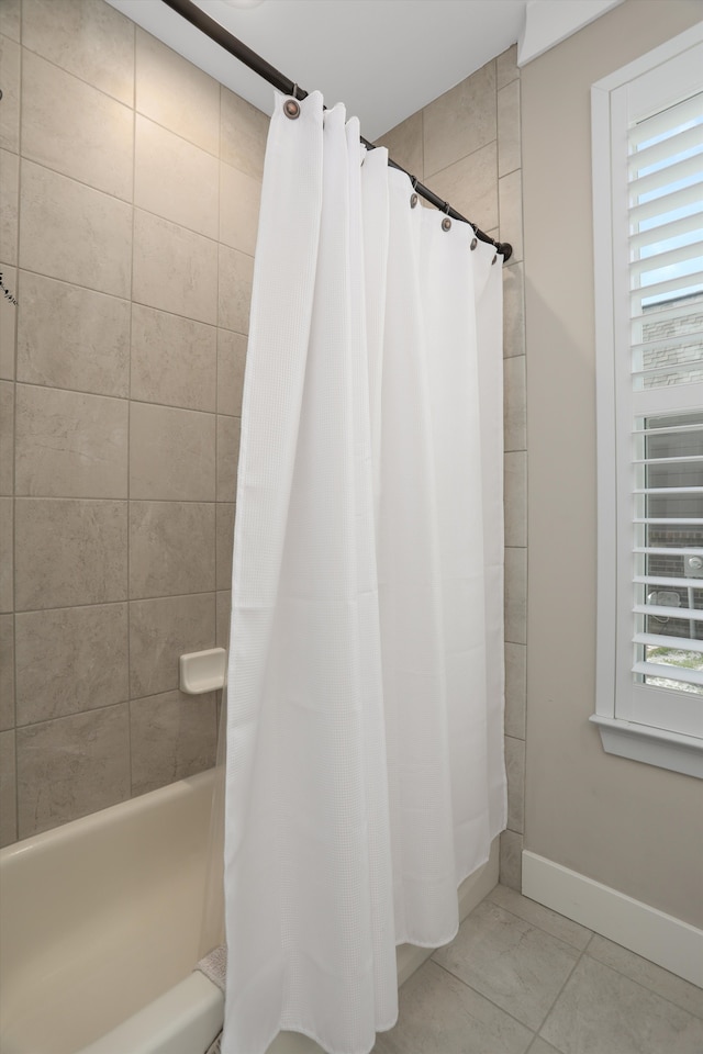 bathroom with shower / tub combo and tile patterned floors