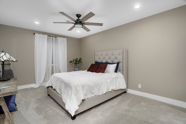 bedroom with ceiling fan and light carpet