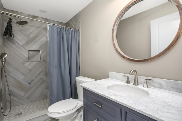 bathroom featuring vanity, toilet, and curtained shower