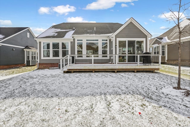 snow covered property with a wooden deck