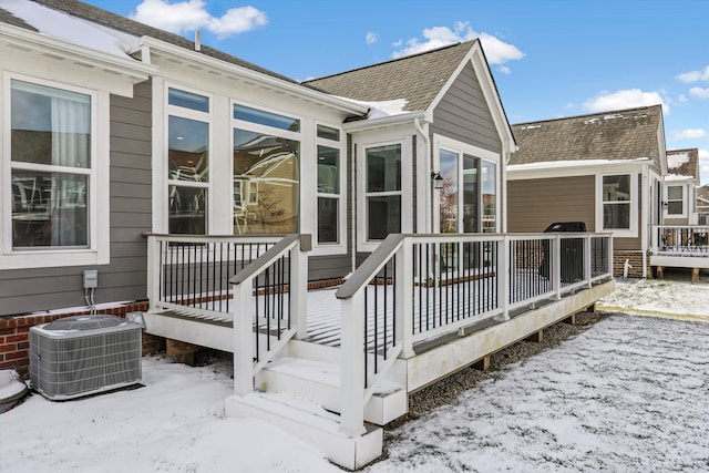 snow covered deck with central AC unit