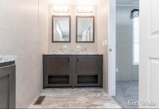 bathroom with vanity and ornamental molding