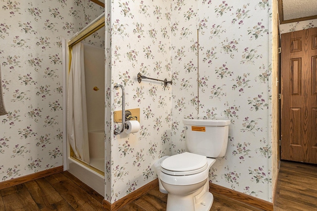 bathroom with toilet, an enclosed shower, and wood-type flooring